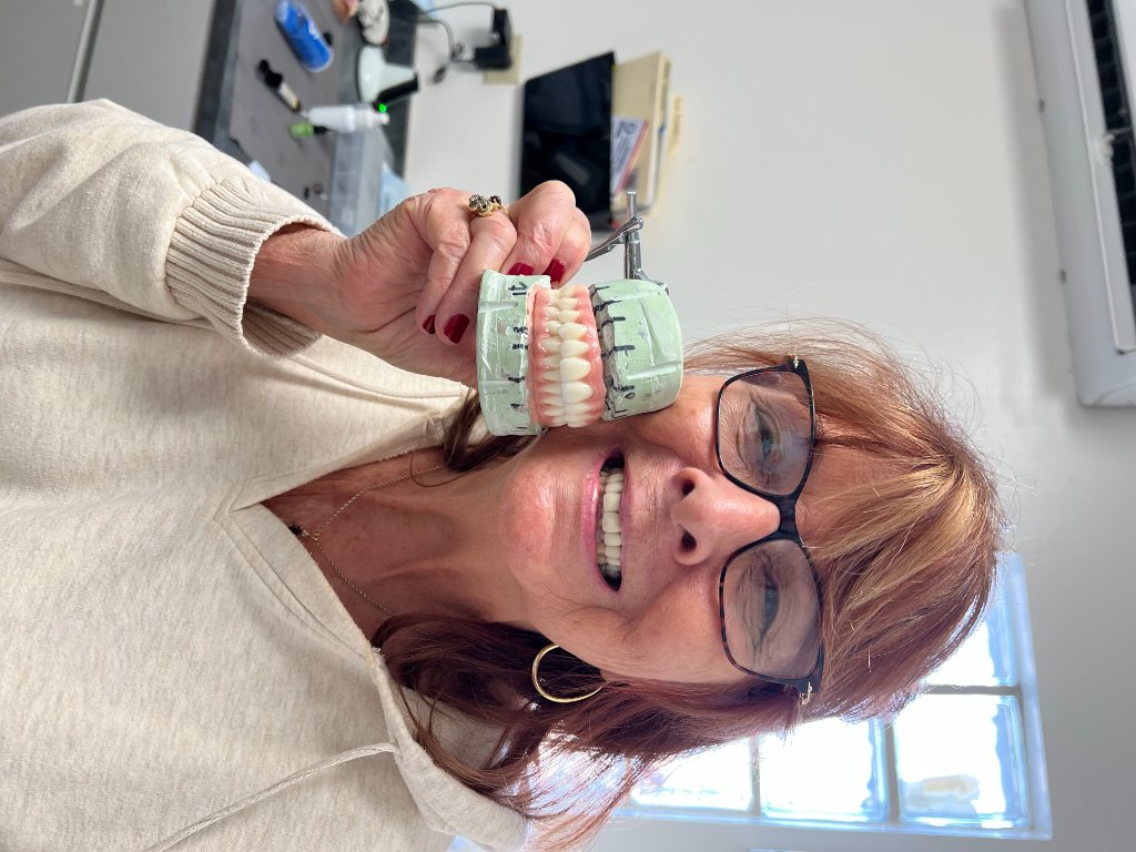 Patient showing a full-arch dental prosthetic restoration